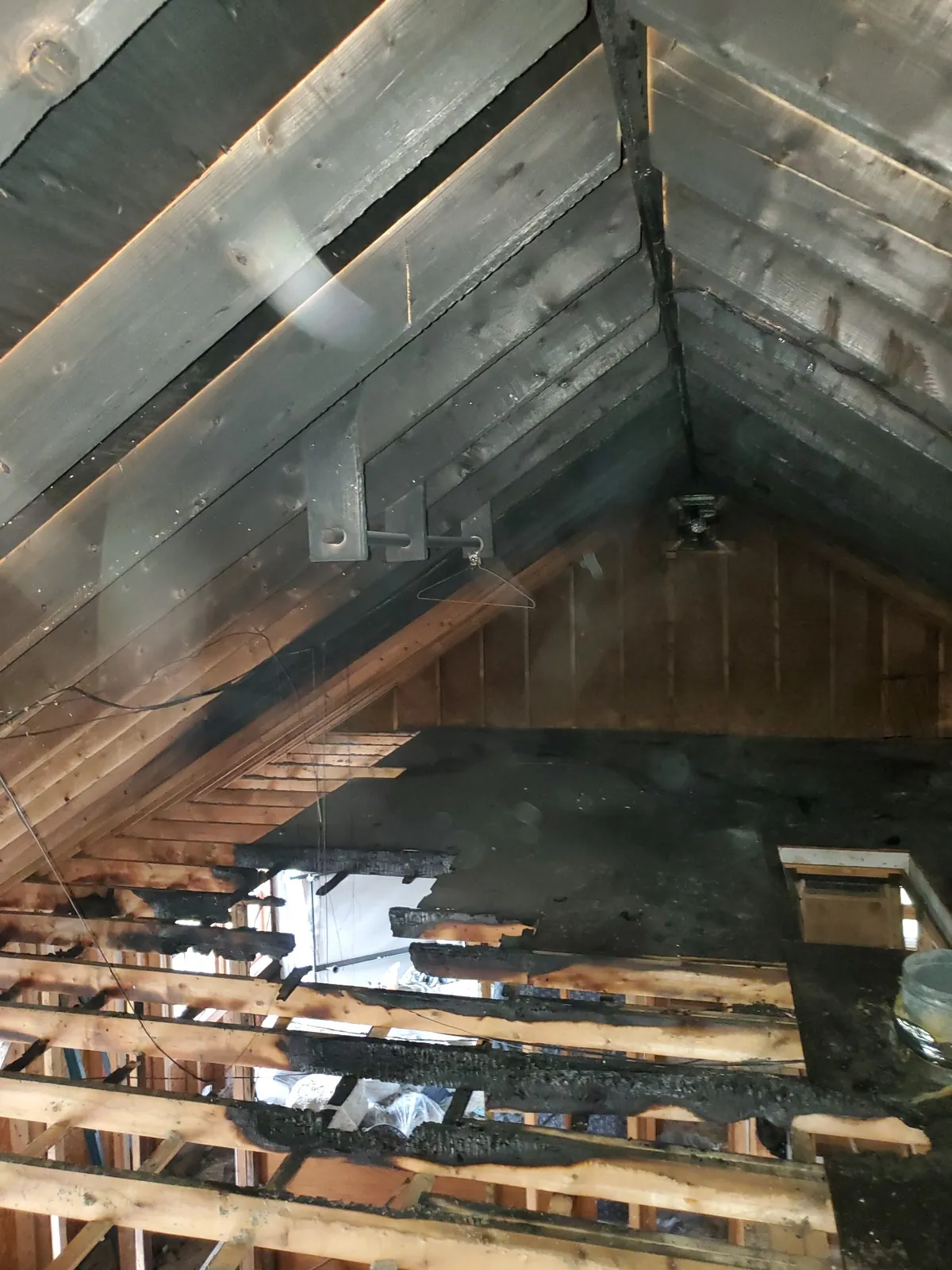 Exposed attic framing during a property restoration.