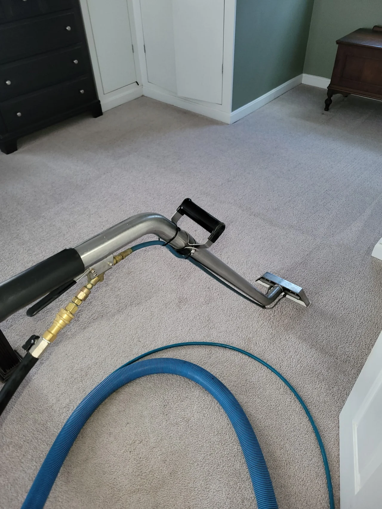 Carpet extraction wand and hose during a Multi-State Restoration carpet cleaning