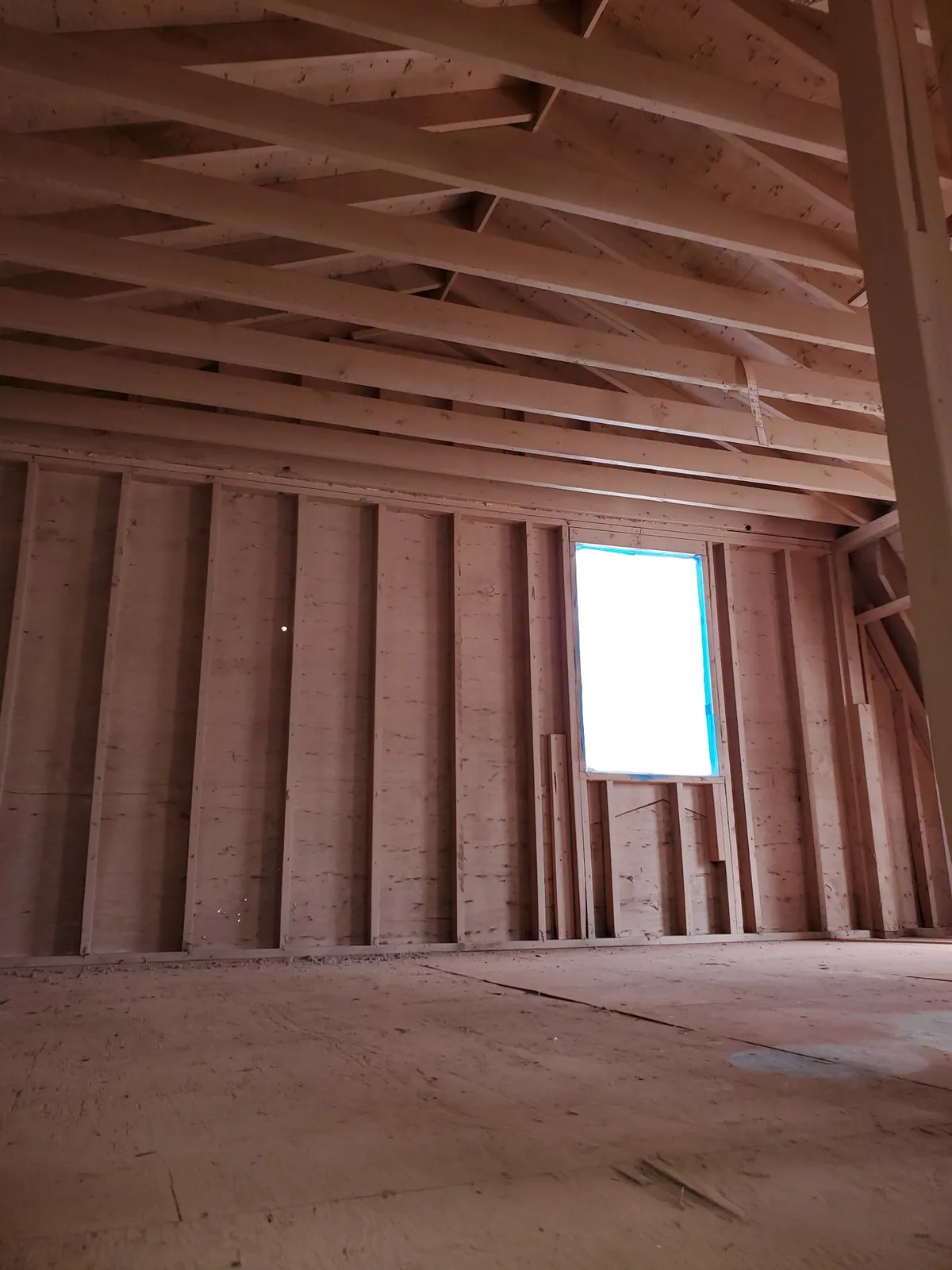 Exposed ceiling and wall framing during reconstruction.
